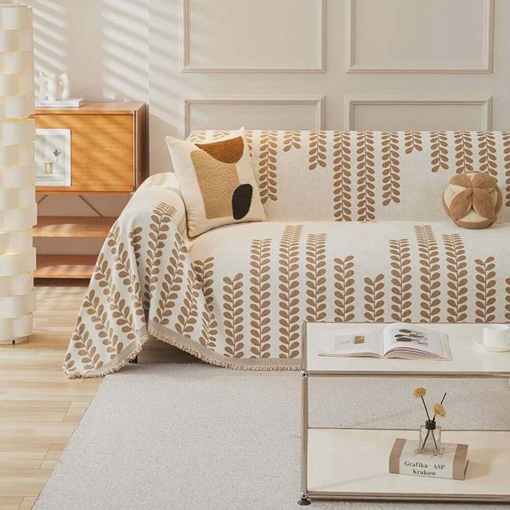 Sohvapeite, jossa on lehväkuvioita ja frangeja – eleganssia ja mukavuutta