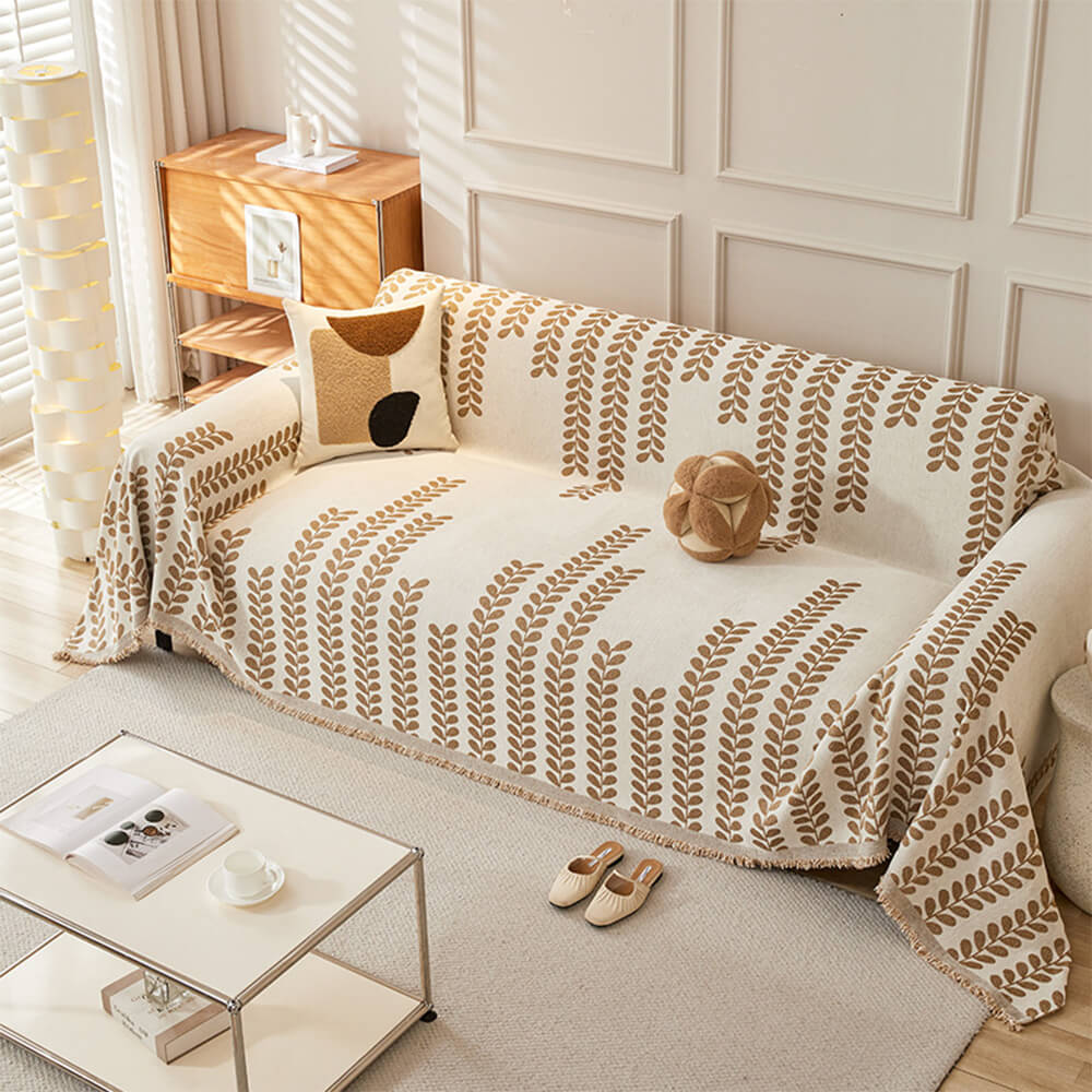 葉とフリンジの模様のソファカバー – 優雅さと快適さ 